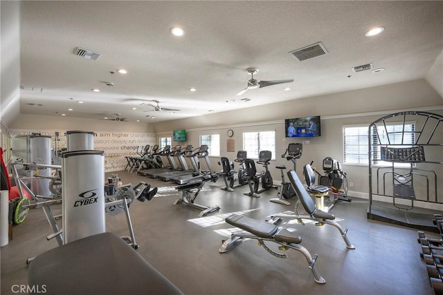 workout area featuring visible vents, ceiling fan, and a textured ceiling