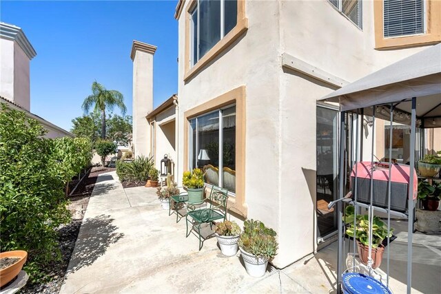 view of side of property with a patio area