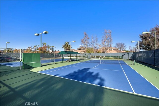 view of tennis court featuring basketball court