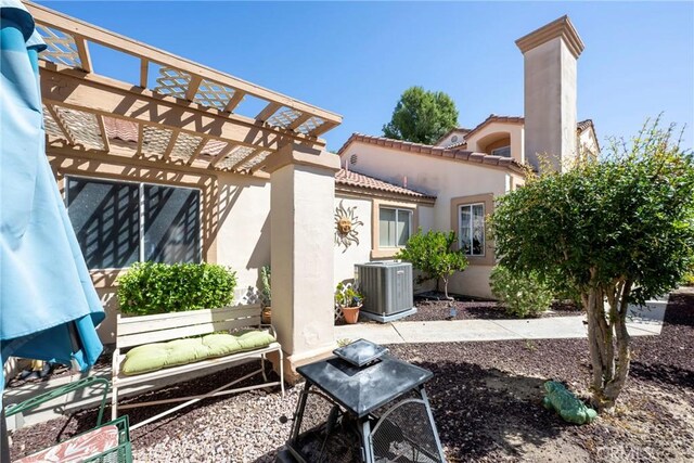 back of house featuring a pergola, a patio, and central AC unit