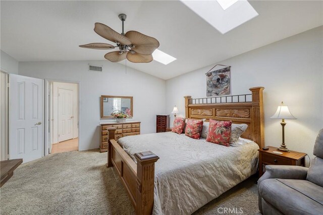 carpeted bedroom featuring ceiling fan and vaulted ceiling with skylight