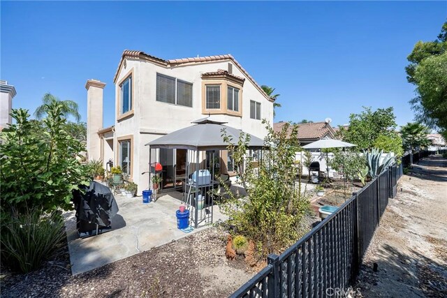 rear view of house featuring a patio area