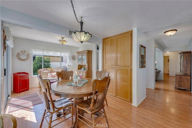 dining area with light hardwood / wood-style floors