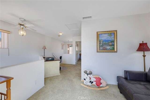 carpeted living room with ceiling fan