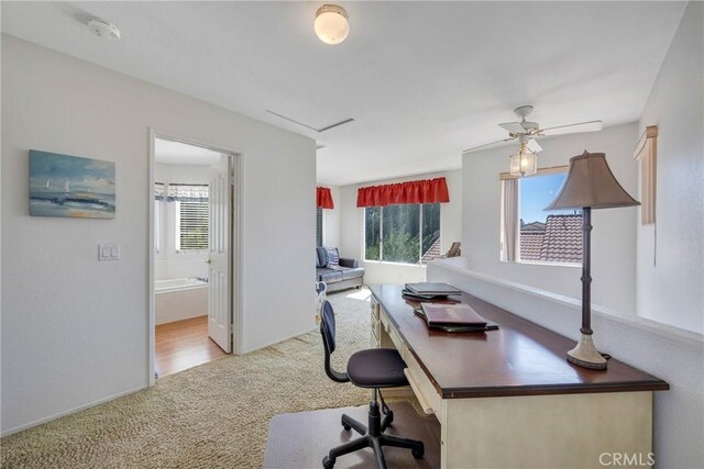 home office featuring ceiling fan and light carpet