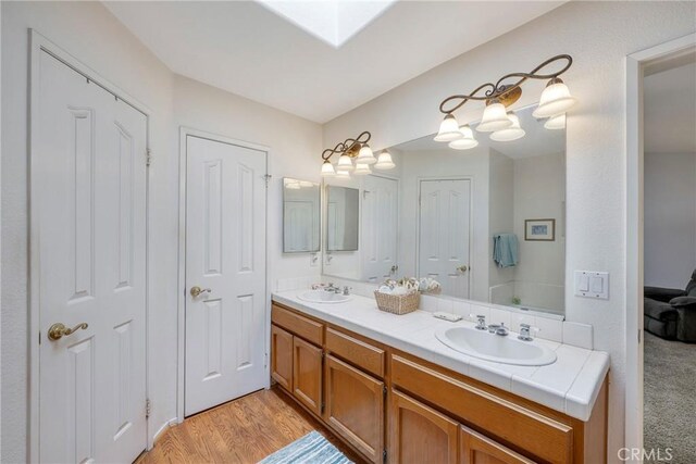 bathroom with hardwood / wood-style flooring and vanity