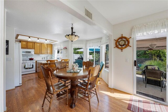 dining area featuring light wood-type flooring