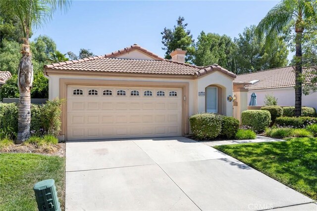 mediterranean / spanish house with a garage