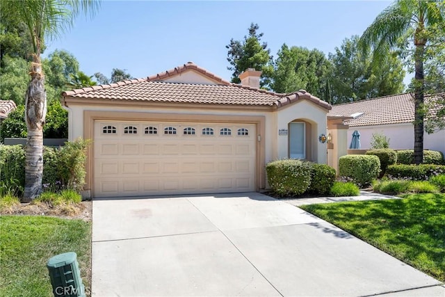 mediterranean / spanish home with a garage, concrete driveway, a tiled roof, and stucco siding