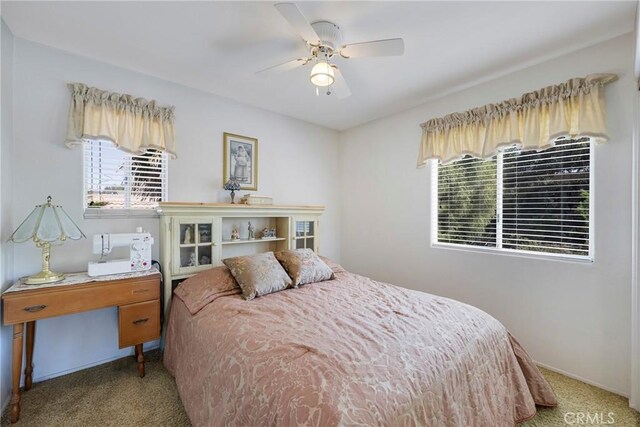 bedroom featuring carpet flooring, multiple windows, and ceiling fan