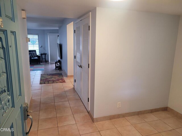 hall with light tile patterned floors