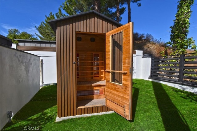 view of outbuilding with a yard