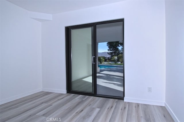 unfurnished room featuring light hardwood / wood-style floors