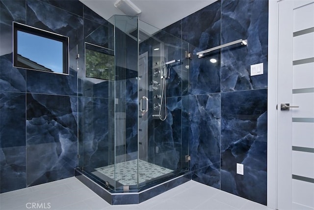 bathroom featuring tile patterned floors and a shower with door