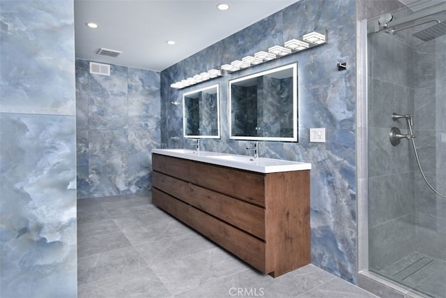 bathroom featuring vanity, tile walls, and walk in shower