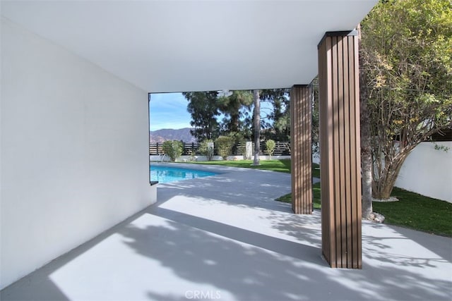 exterior space featuring a mountain view and concrete floors