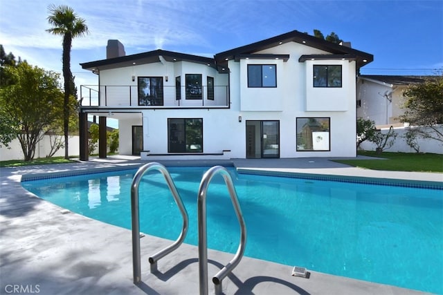 exterior space with a balcony and a patio