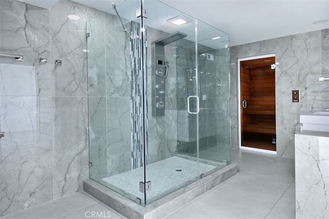 bathroom featuring an enclosed shower and tile walls