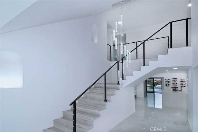 stairs featuring a high ceiling