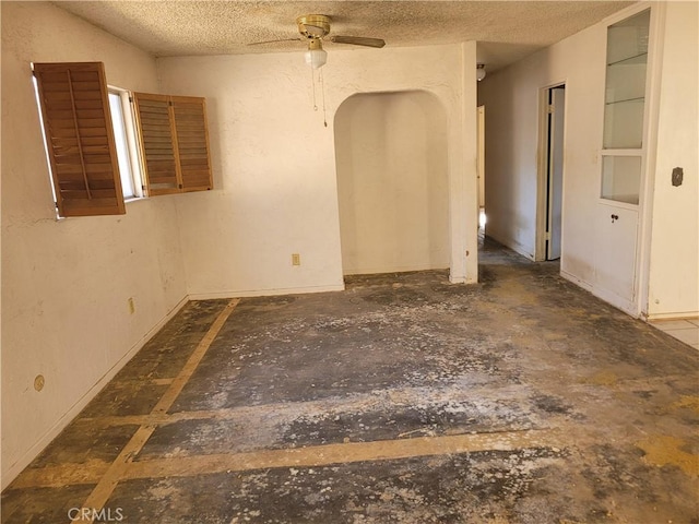 spare room featuring ceiling fan and a textured ceiling