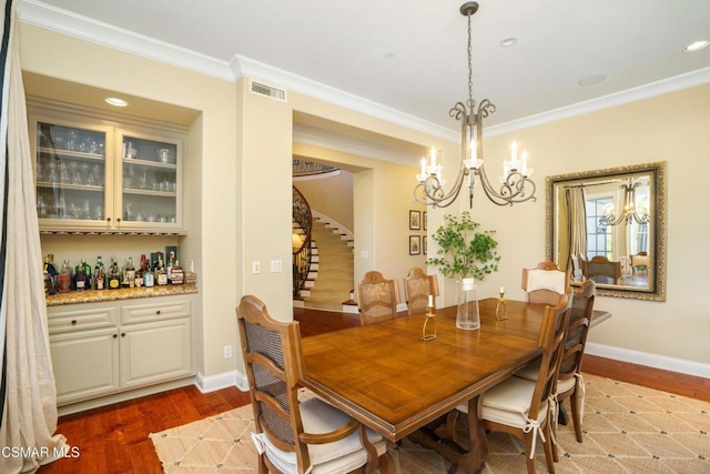 dining space with ornamental molding and dark wood-type flooring