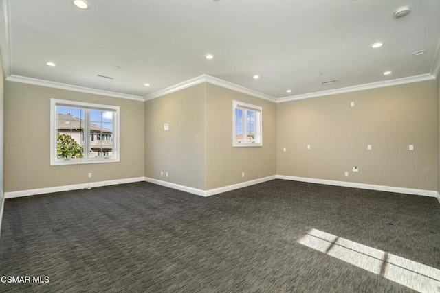 empty room featuring crown molding and dark carpet