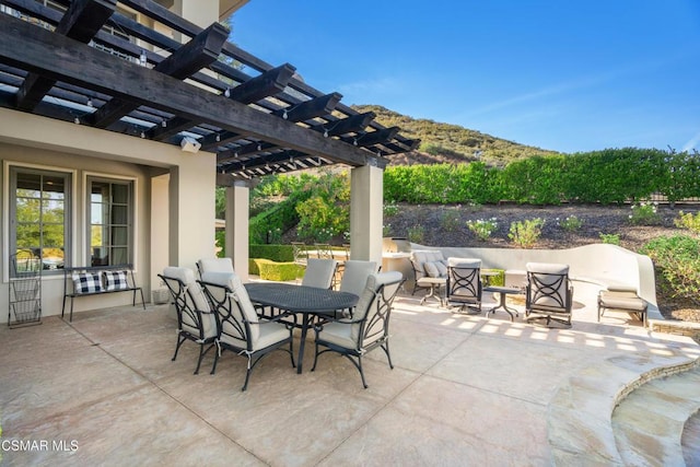 view of patio with a mountain view and a pergola