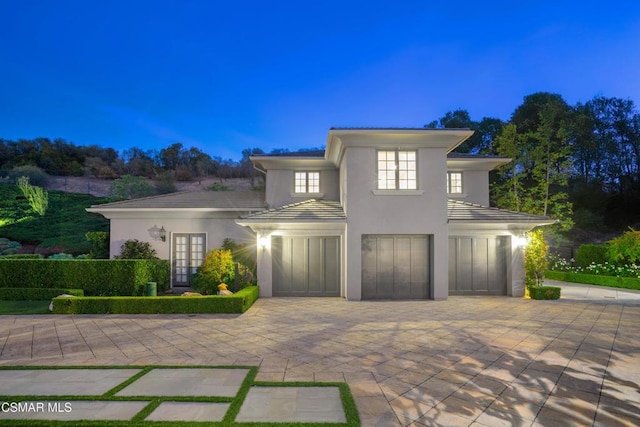 view of front facade with a garage and french doors