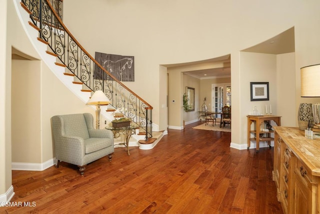 foyer entrance with ornamental molding and hardwood / wood-style flooring