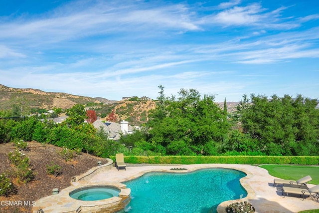 view of swimming pool with a mountain view, an in ground hot tub, and a patio