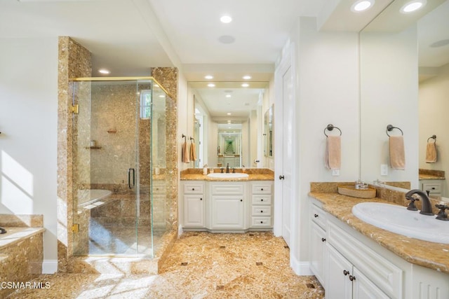 bathroom featuring vanity and a shower with door