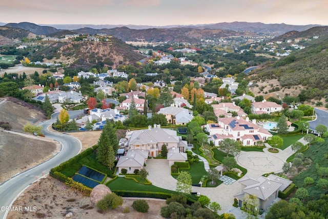 aerial view at dusk featuring a mountain view