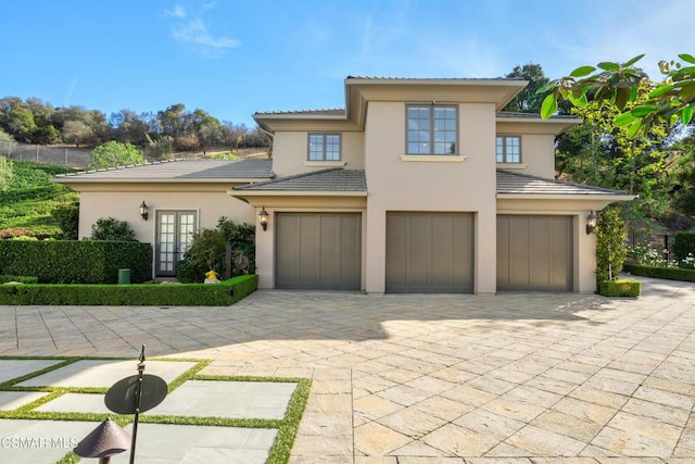 view of front of property featuring french doors and a garage