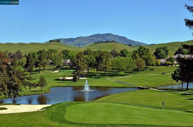 view of community featuring a yard and a water and mountain view