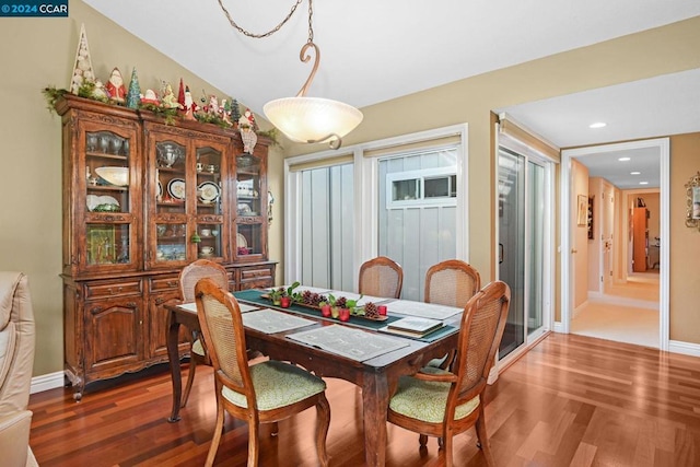 dining area featuring dark hardwood / wood-style floors and lofted ceiling