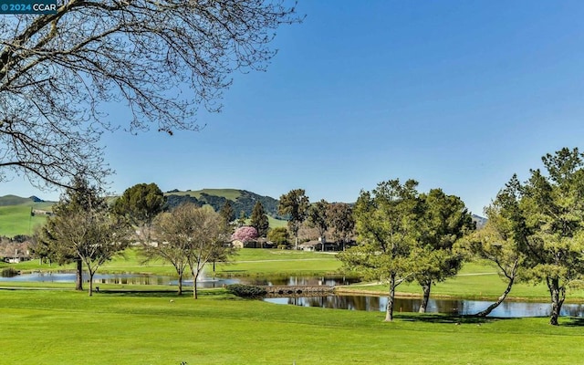 surrounding community featuring a yard and a water and mountain view