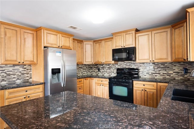 kitchen with black appliances, sink, backsplash, and dark stone counters