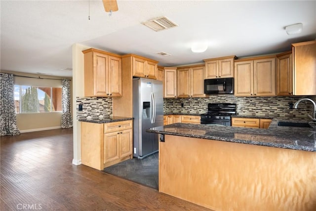 kitchen featuring backsplash, sink, black appliances, and dark hardwood / wood-style floors