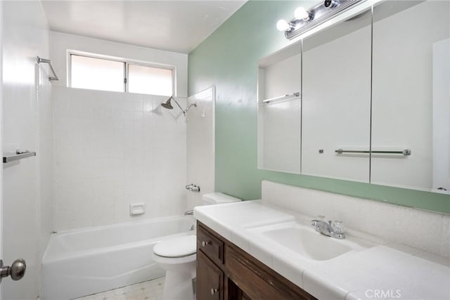 full bathroom featuring vanity, tiled shower / bath combo, and toilet