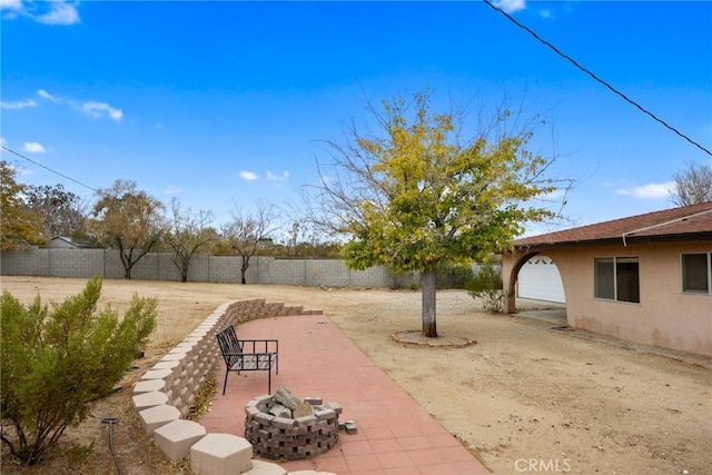 view of yard featuring a patio and a fire pit