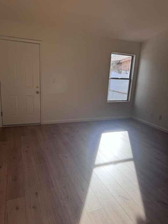 empty room with light hardwood / wood-style flooring