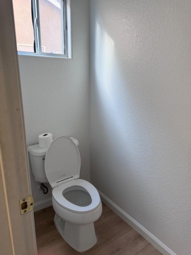 bathroom featuring hardwood / wood-style floors and toilet