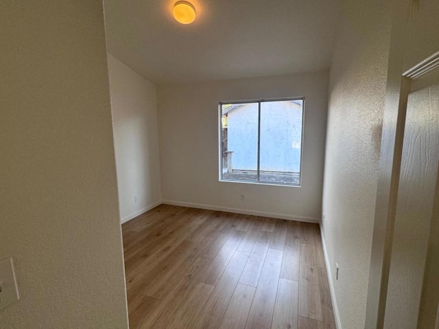 spare room with light hardwood / wood-style floors