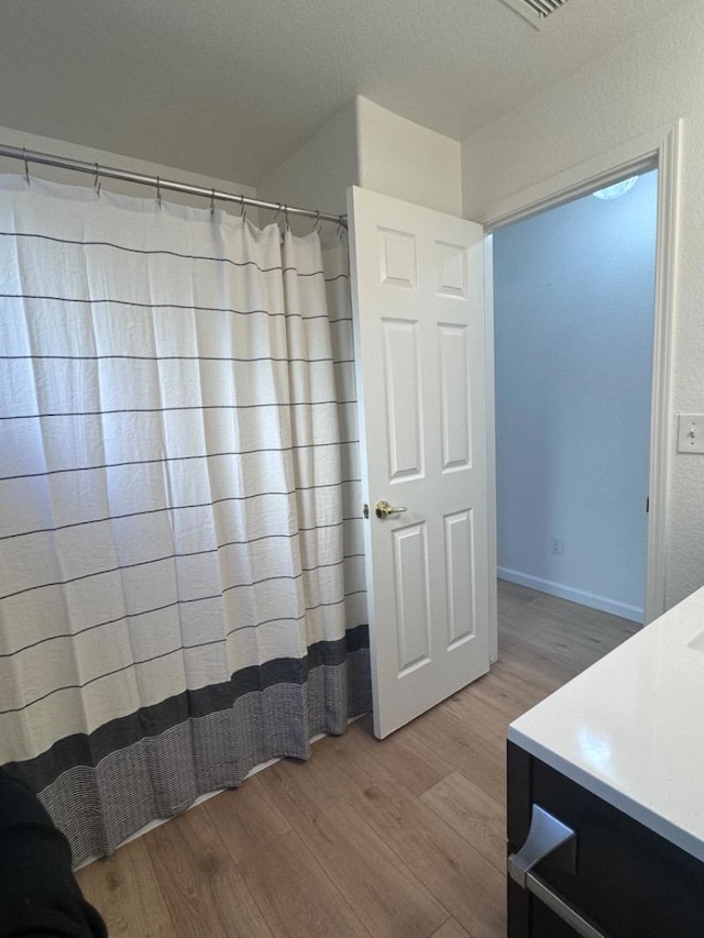 bathroom with hardwood / wood-style flooring and vanity