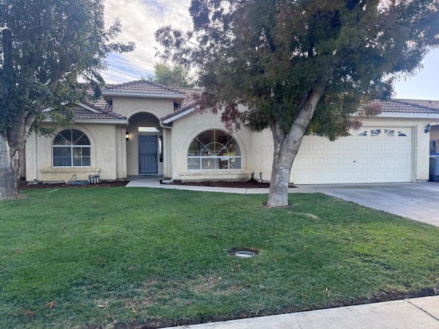 view of front of property featuring a garage and a front lawn