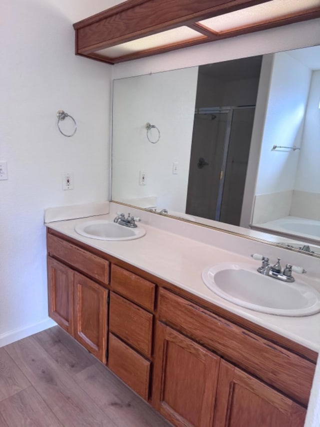 bathroom featuring hardwood / wood-style floors, vanity, and separate shower and tub