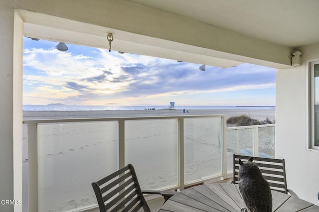 balcony with a beach view and a water view