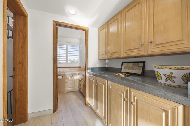 kitchen featuring light brown cabinetry and light hardwood / wood-style flooring