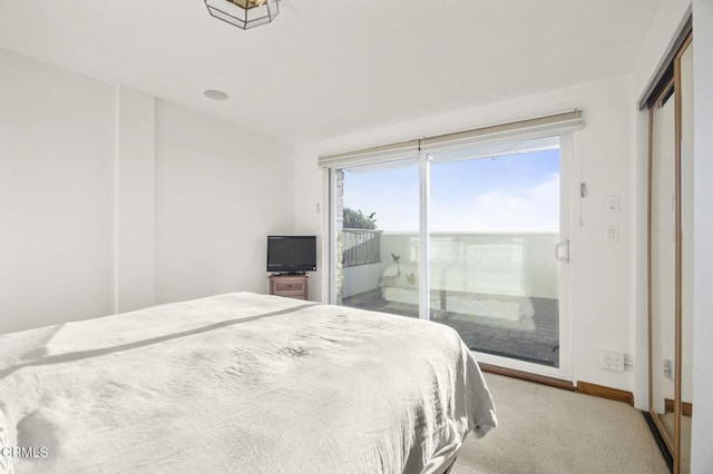 carpeted bedroom featuring access to outside