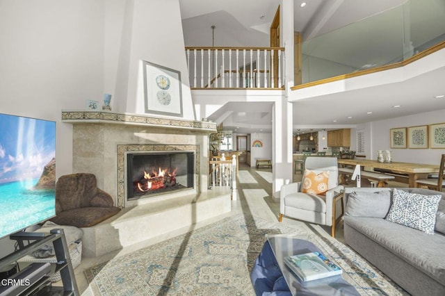 living room with high vaulted ceiling and a premium fireplace